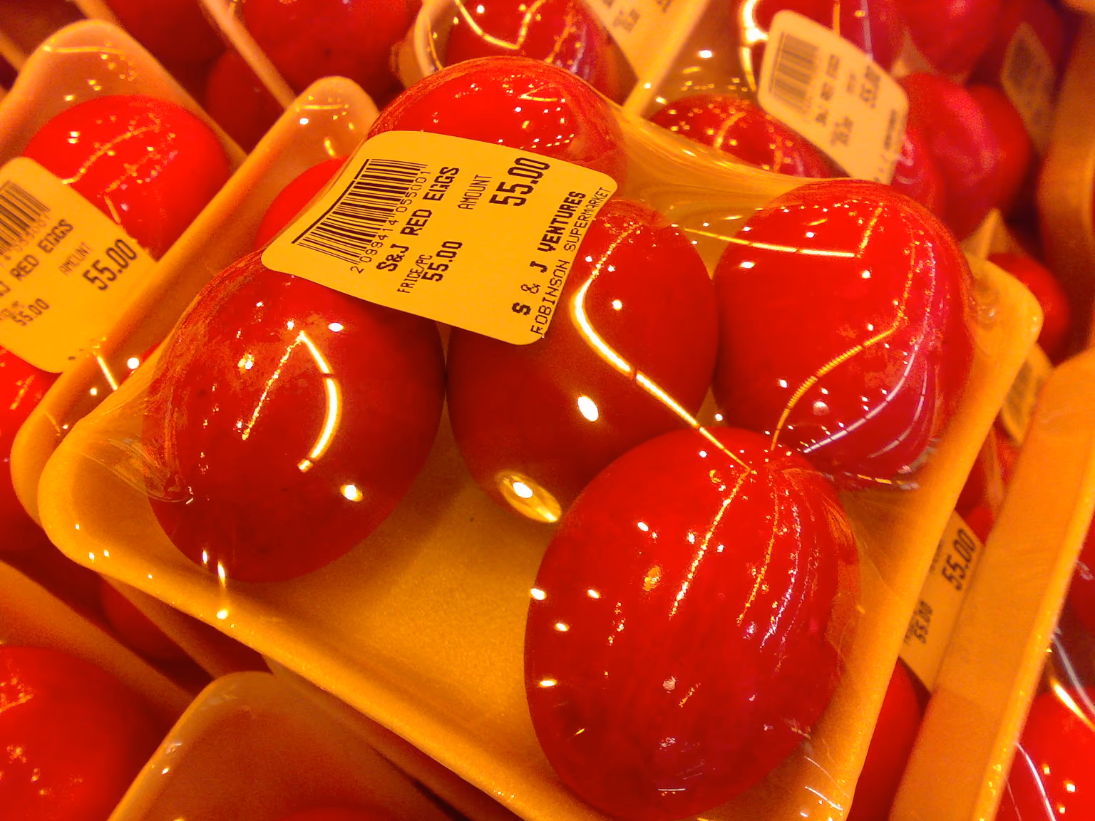 Red salted eggs wrapped in plastic trays